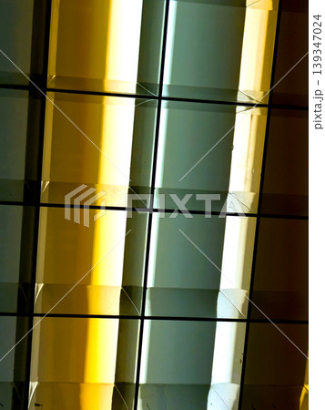 Directional LED lights on rails under the ceiling abstract lines in orange and white 139347024