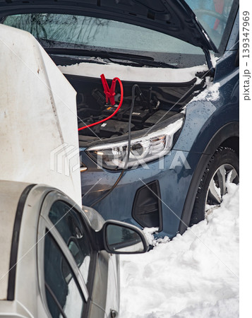 Car is being jump started in snowy weather in winter season during daylight hours Car is being jump started in snowy weather in winter season during daylight hours 139347969