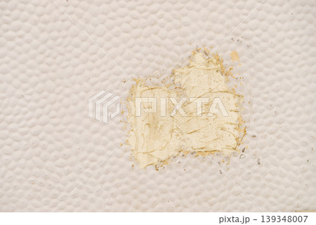 Painted wall in caravan shows wear with a patch of yellow paint and textured surface, highlighting repair work and surface details 139348007