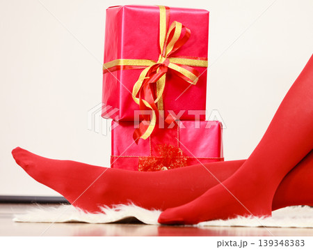 Female with many gift boxes sitting on floor 139348383