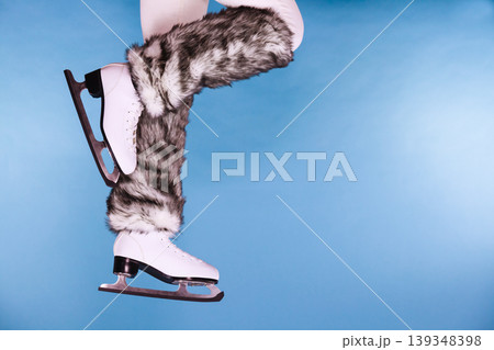 Woman legs wearing ice skates fur socks, skating 139348398