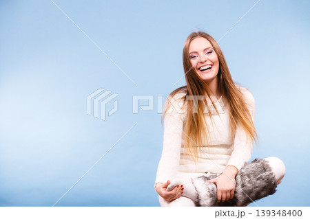 Sitting smiling woman wearing furry shoes 139348400