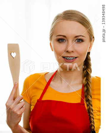 Woman holding wooden spatula with heart 139348498