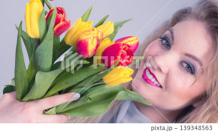 Pretty woman with red yellow tulips bunch Pretty woman with red yellow tulips bunch 139348563