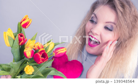 Woman holds tulips and red heart 139348564