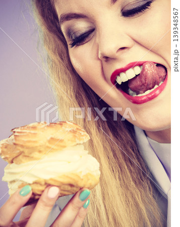 Funny woman holds cream puff cake 139348567