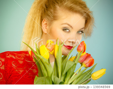 Pretty woman with red yellow tulips bunch Pretty woman with red yellow tulips bunch 139348569
