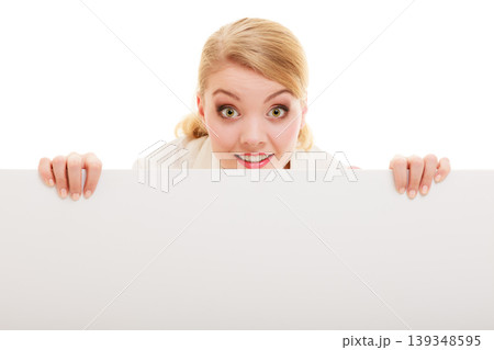 Businesswoman hiding behind blank copy space banner 139348595