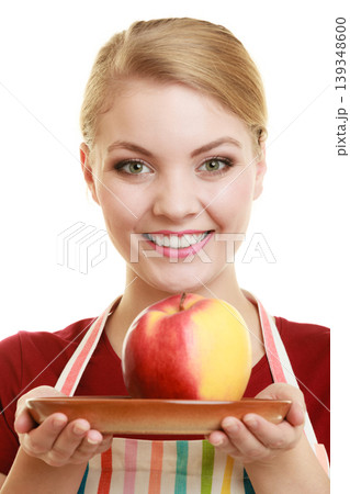 housewife in kitchen apron offering apple healthy fruit housewife in kitchen apron offering apple healthy fruit 139348600