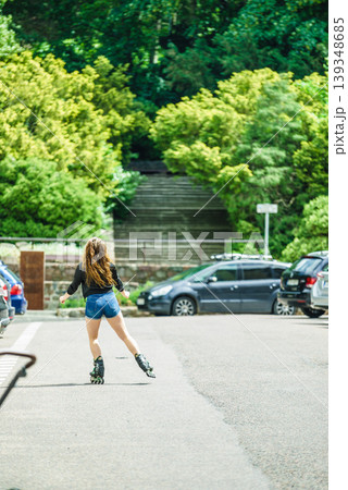 Young woman riding roller skates Young woman riding roller skates 139348685