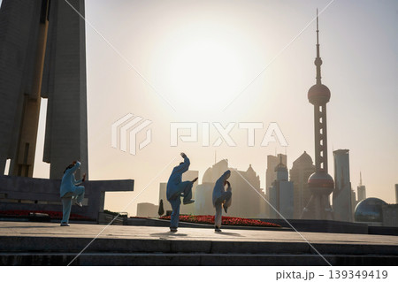 Chinese people Tai Chi at People's tower at sunrise, Shanghai Chinese people Tai Chi at People's tower at sunrise, Shanghai 139349419