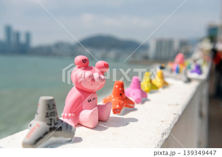 Pink art toy clay on wall by coastal at Huinnyeoul Village, Busan 139349447