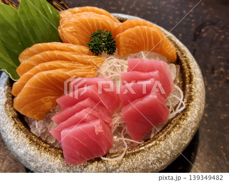 Tuna and Salmon Sashimi on Bowl over Japanese restaurant table Tuna and Salmon Sashimi on Bowl over Japanese restaurant table 139349482