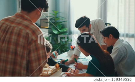 Group of diverse team planning strategy while sitting at table. Alimentation. Group of diverse team planning strategy while sitting at table. Alimentation. 139349556