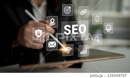 Professional Business Person Using Tablet to Engage with Digital SEO Concepts and Icons for Search Engine Optimization Strategies Ledger Professional Business Person Using Tablet to Engage with Digital SEO Concepts and Icons for Search Engine Optimization Strategies Ledger 139349797