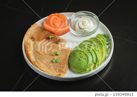 Roasted thin pancakes with smoked salmon and sauce Roasted thin pancakes with smoked salmon and sauce 139349911