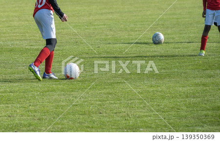 Soccer Players Training on Grass Field Soccer Players Training on Grass Field 139350369