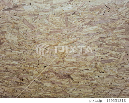 The scene presents a detailed view of oriented strand board textured surface, highlighting the arrangement of compressed wood flakes and chips. The scene presents a detailed view of oriented strand board textured surface, highlighting the arrangement of compressed wood flakes and chips. 139351218