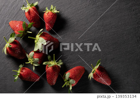Organic Strawberries on Dark Granite Background. Organic Strawberries on Dark Granite Background. 139353134