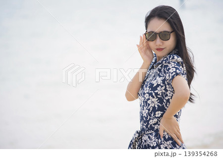 海辺に立つサングラス姿の女性 139354268