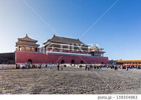 View of Forbidden City South gate compound during sunrise with distant and blurry unrecognizable tourists crowd 139354963