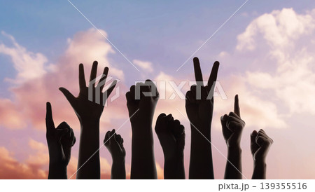 Group of raised hands protest gesture against sky, freedom expression, social movement 139355516