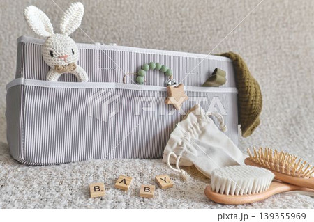 Baby organizer basket with toys and personal care items Baby organizer basket with toys and personal care items 139355969