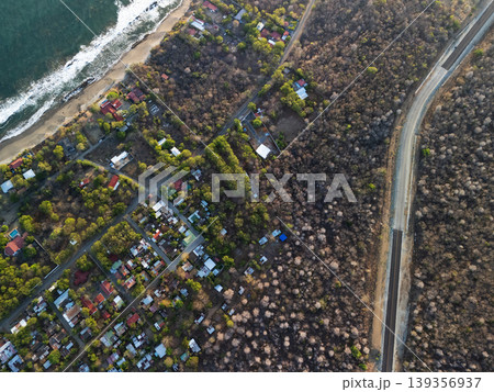 Coastal view of houses and road near beach at sunset Coastal view of houses and road near beach at sunset 139356937