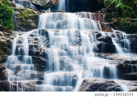 Waterfall cascading over rocky terrain in tropical forest at Vietnam 139358155