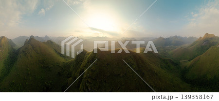 Sunrise over Ba Guang grass hill, Mountain range along with villager bringing horse to graze on the mountain at Vietnam Sunrise over Ba Guang grass hill, Mountain range along with villager bringing horse to graze on the mountain at Vietnam 139358167