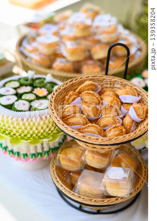 Beautiful and appetizing traditional Thai desserts including crispy curry puffs, sweet treats and jelly desserts on dessert table Beautiful and appetizing traditional Thai desserts including crispy curry puffs, sweet treats and jelly desserts on dessert table 139358204
