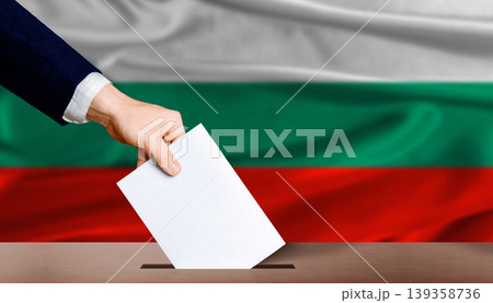 Hand placing a ballot in ballot box with the Bulgarian flag in the background. Bulgaria Parliamentary vote Hand placing a ballot in ballot box with the Bulgarian flag in the background. Bulgaria Parliamentary vote 139358736
