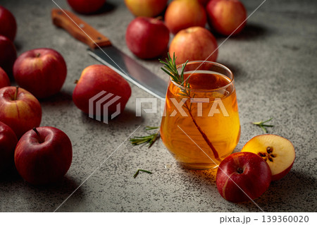 Apple juice and fresh apples on a kitchen table. Apple juice and fresh apples on a kitchen table. 139360020