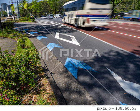 左折専用レーンに沿う自転車ナビラインと大型車が通過する都市の道路 左折専用レーンに沿う自転車ナビラインと大型車が通過する都市の道路 139360355