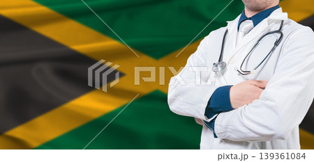 Jamaica healthcare concept. Male doctor on Jamaica flag. Doctor with crossed arms on Jamaica flag 139361084