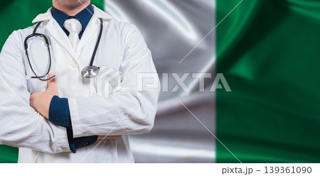 Male doctor with stethoscope on Nigerian flag. Doctor holding stethoscope on Nigeria flag Male doctor with stethoscope on Nigerian flag. Doctor holding stethoscope on Nigeria flag 139361090