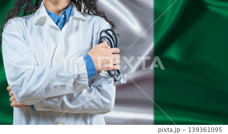 Healthcare professional with Nigeria flag background. Professional doctor holding stethoscope on Nigeria flag background Healthcare professional with Nigeria flag background. Professional doctor holding stethoscope on Nigeria flag background 139361095