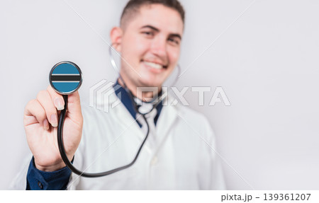 Doctor showing stethoscope with Botswana flag. Botswana national healthcare concept Doctor showing stethoscope with Botswana flag. Botswana national healthcare concept 139361207