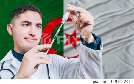 Doctor holding syringe on Algeria flag background. Medical professional holding syringe with Algerian flag in the background Doctor holding syringe on Algeria flag background. Medical professional holding syringe with Algerian flag in the background 139361208