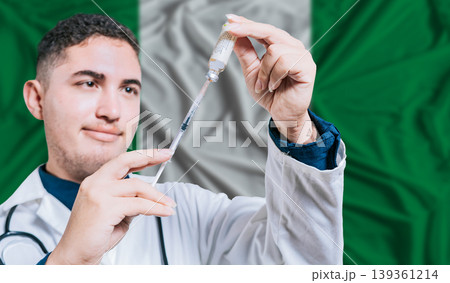 Doctor holding syringe on Nigeria flag background. Medical professional holding syringe with Nigerian flag in the background 139361214