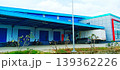 Modern Warehouse with a Blue Roof and Delivery Truck 139362226