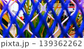 Blue Wire Fence with Colorful Plants in the Background 139362262
