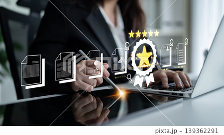 Professional Businessperson Evaluating Documents with Digital Graphics of Quality and Performance Metrics on Modern Laptop Fluxor 139362291