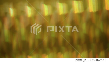 Striped blur glow. Leak prism. Kaleidoscopic pattern light wavy reflection. Yellow green color crystal lens texture abstract background. 139362548