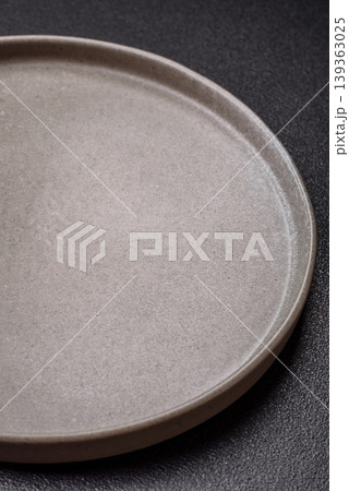 An empty ceramic round plate, kitchen utensils for a dinner table. An empty plate An empty ceramic round plate, kitchen utensils for a dinner table. An empty plate 139363025