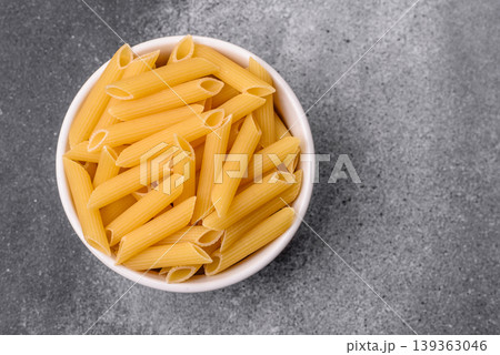 Italian uncooked dry penne regate pasta ready for cooking. Dry penne pasta 139363046