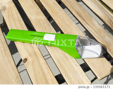 Green insect and spider catcher with a transparent capture section, presenting a simple solution for safe insect handling. 139363171