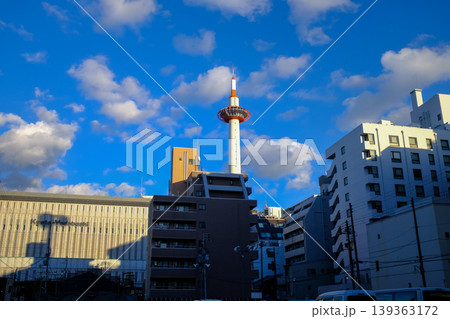 Low angle view of Kyoto Tower with blue sky, Kyoto, Japan. Kyoto, Japan cityscape. Travel concept. Kyoto tower is the tallest building and a major tourist attraction in Kansai region in Japan. Low angle view of Kyoto Tower with blue sky, Kyoto, Japan. Kyoto, Japan cityscape. Travel concept. Kyoto tower is the tallest building and a major tourist attraction in Kansai region in Japan. 139363172