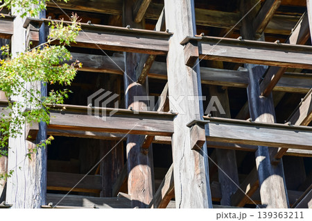 Close-up of the structure of kiyomizu-dera temple with trees in Kyoto, Japan. Major tourist attraction in Kansai region in Japan. Japan famous historic architecture. Building abstract. Travel concept Close-up of the structure of kiyomizu-dera temple with trees in Kyoto, Japan. Major tourist attraction in Kansai region in Japan. Japan famous historic architecture. Building abstract. Travel concept 139363211