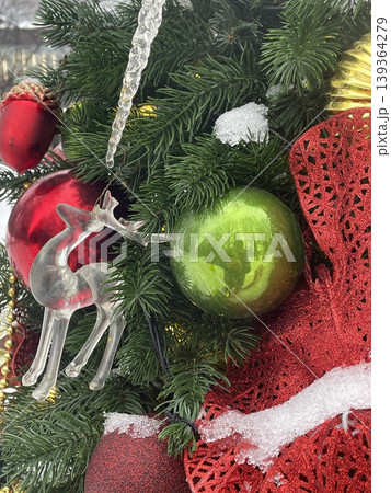 Christmas tree adorned with ornaments, icicle, and snow for festive holiday background 139364279